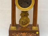 a clock that is sitting on top of a wooden stand