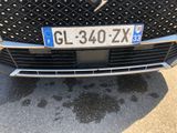a close up of a car ' s grille with a number plate on it