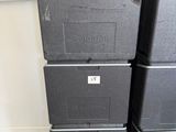 three black boxes are stacked on top of each other in a room