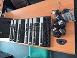 a lot of keyboards and mouses on the desk