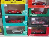 many different models of cars in boxes on the table