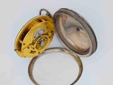 a gold pocket watch with a magnifying glass in it