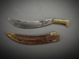 two knives are sitting next to each other on a gray surface