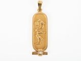 an image of a gold pendant with a bird and a bird on it