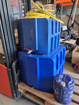 a stack of blue containers sitting on top of a pallet