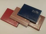 three different types of leather folders sitting on top of a table
