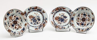 four plates with floral designs on them on a white surface
