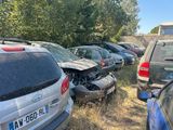 many cars that are parked on the side of the road