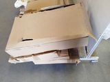 a pile of boxes sitting on the floor next to a wall