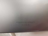 the back of a silver laptop computer sitting on top of a table