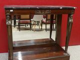 an old wooden table with a mirror on top of it