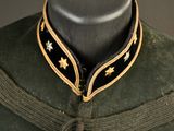 a green uniform with gold stars on the collar