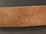 a close up of a piece of brown leather on a table