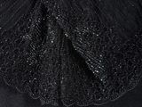 the back view of a black dress with a collar and a beaded neckline