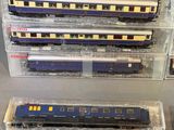 several model trains are sitting on a table in a display case