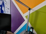 a desk with a laptop and a phone on it