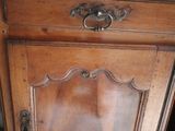 a wooden cabinet with a metal handle on it