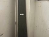a surfboard leaning up against a wall in a small room