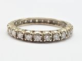 a close up of a diamond ring on a white surface