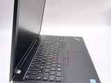 a laptop with a black keyboard on a white surface