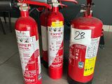 three fire extinguisors sitting on the floor next to each other