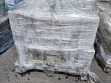 a large pile of plastic bags sitting on top of a pile of pallets