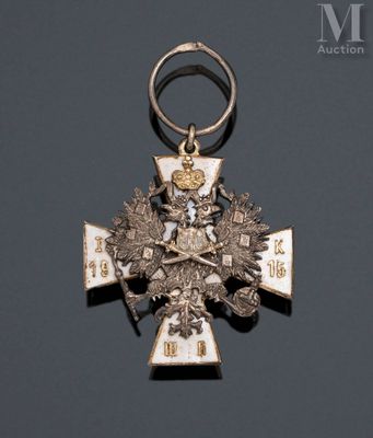 a silver and gold medal with a cross on it