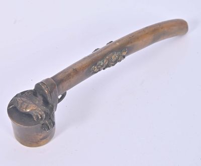 a small pipe with a handle on a white surface