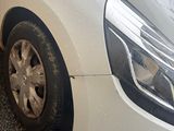 a white car that is parked on the side of the street
