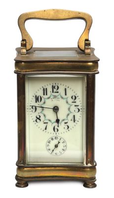 an image of a small clock sitting on top of a table