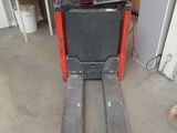 a fork lifter that is sitting in the garage