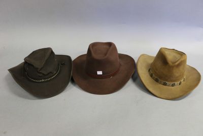 three different hats are lined up on a white surface