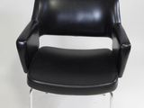 an image of a black leather chair with chrome legs