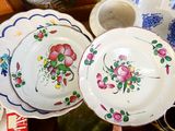 two plates with flowers on them sitting on a table