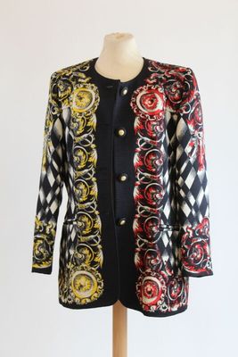 a woman ' s black and white jacket with red, yellow, and black designs