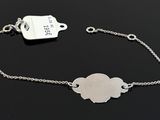 sterling silver bracelet with a hametle charm on a black background