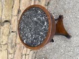 a black and white marble table with a wooden base