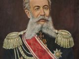 portrait of a man with a long beard wearing a red sash