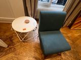 a chair and a table in the corner of a room