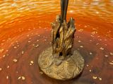 a candle that is sitting in a bowl on the table