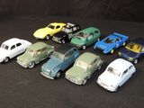 several toy cars are lined up in a row on a black surface