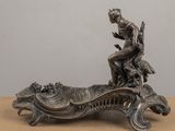 an image of a statue of a man sitting on top of a boat