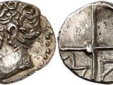 a silver coin with an image of a man on it