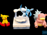three figurines of pokemon characters on a black background