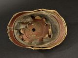an old helmet with a hole in the middle of it