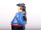 a figurine of a woman wearing a hat and a blue jacket