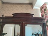 a large wooden cabinet with a mirror on top of it