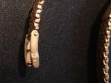 a close up of a gold bracelet with a clasp on it