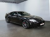 the black sports car is parked in the garage of the building