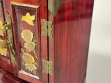 a small wooden box with gold decorations on it